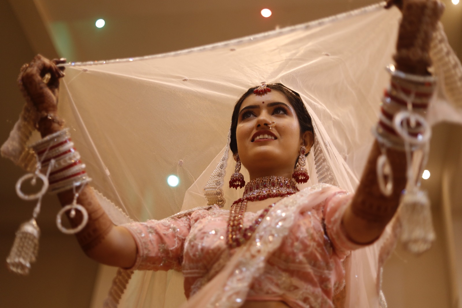 Bride lifting her veil during a wedding portrait