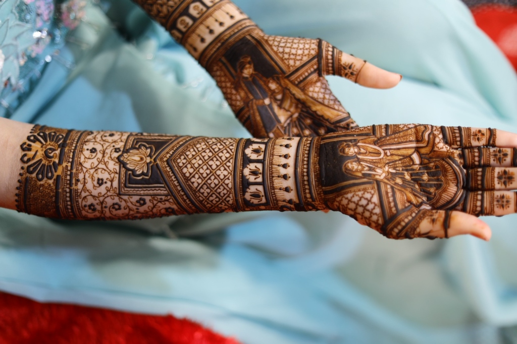 Stunning bride and groom portrait mehndi on both palms